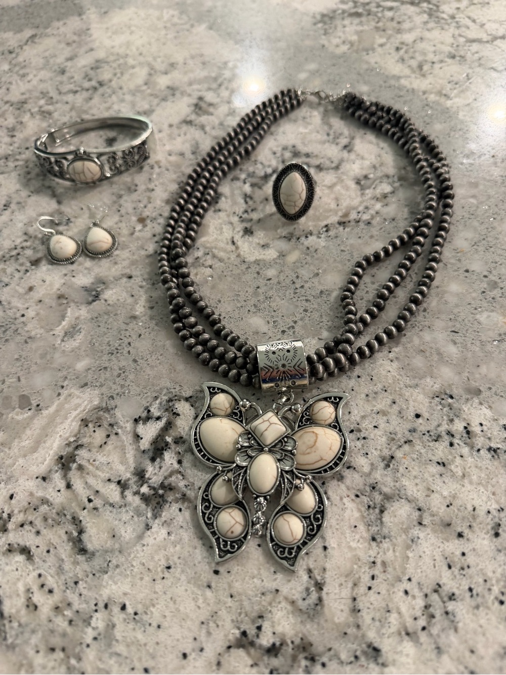 Triple-Strand Silver Necklace with Cream Stone Butterfly Pendant